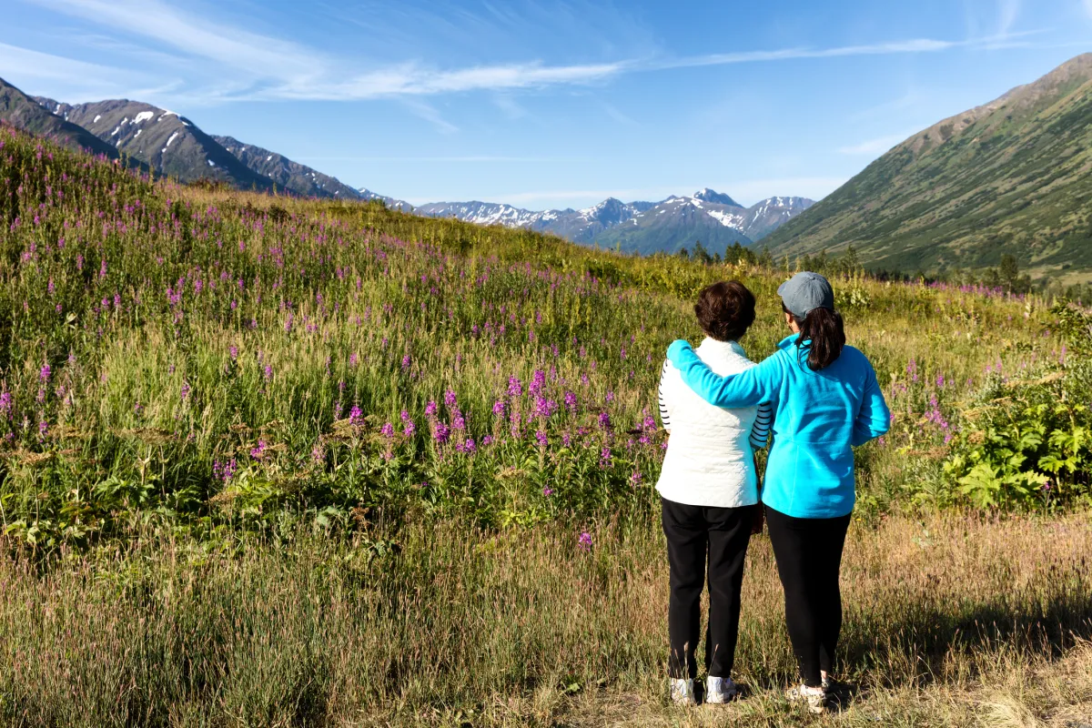 Mother and daughter looking at wild flowers